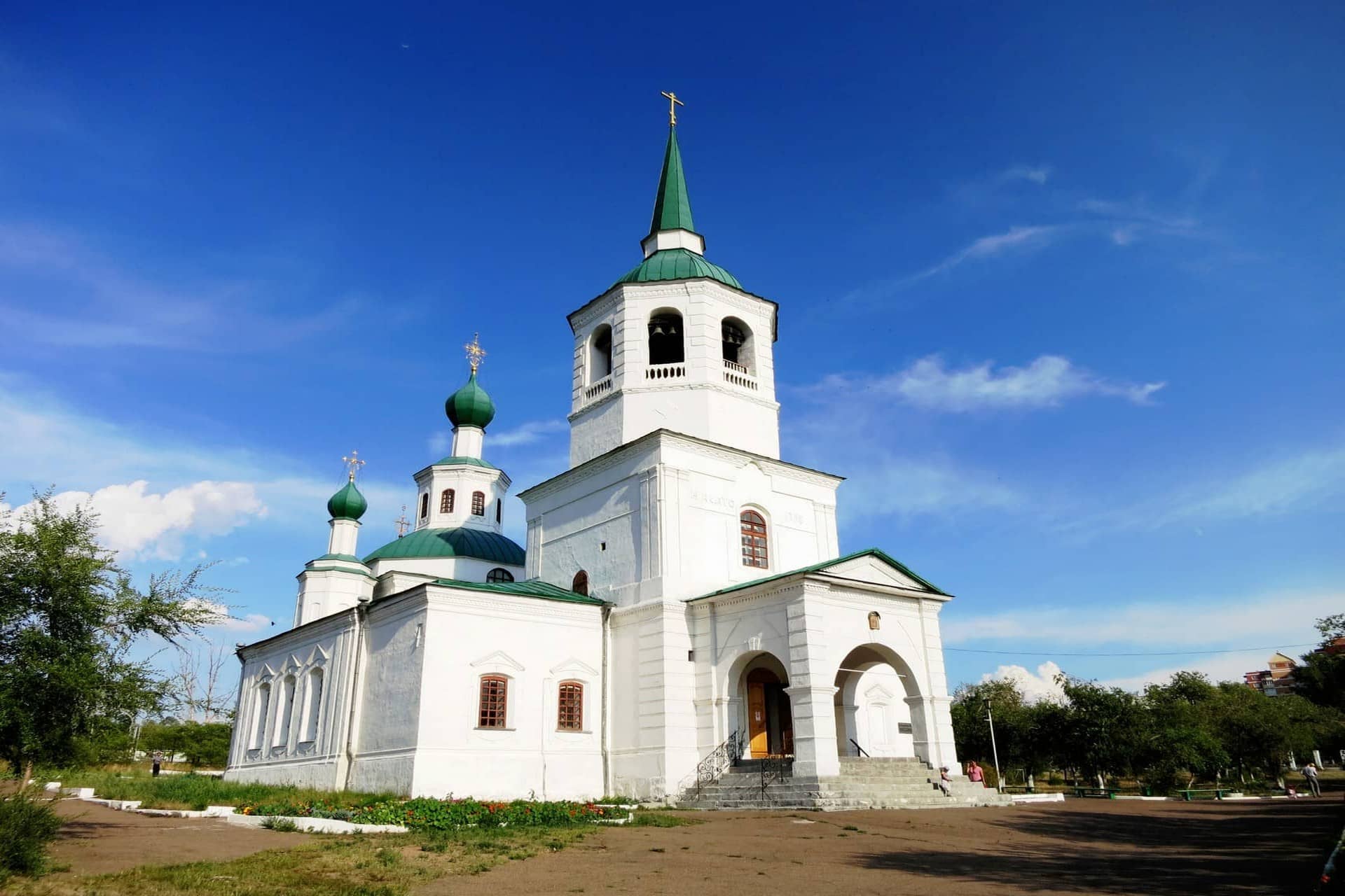 A white Orthodox Church with green domes