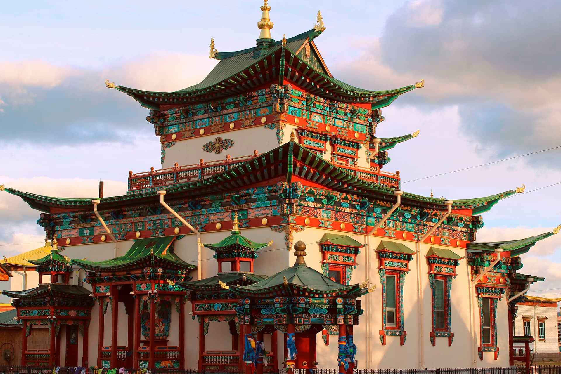 A colorful Buddhist Temple with green roof and orange decorations