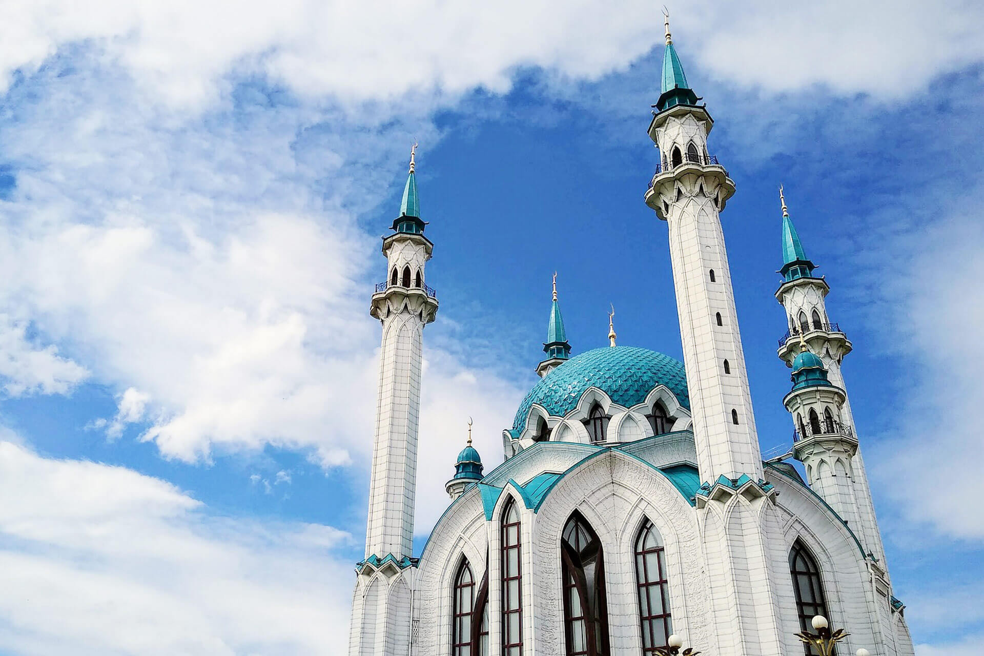 Kazan, White mosque with blue dome and minarets against the background of the blue sky with clouds.