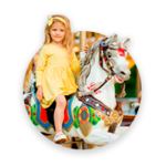 A cute girl riding a toy horse, amusement ride