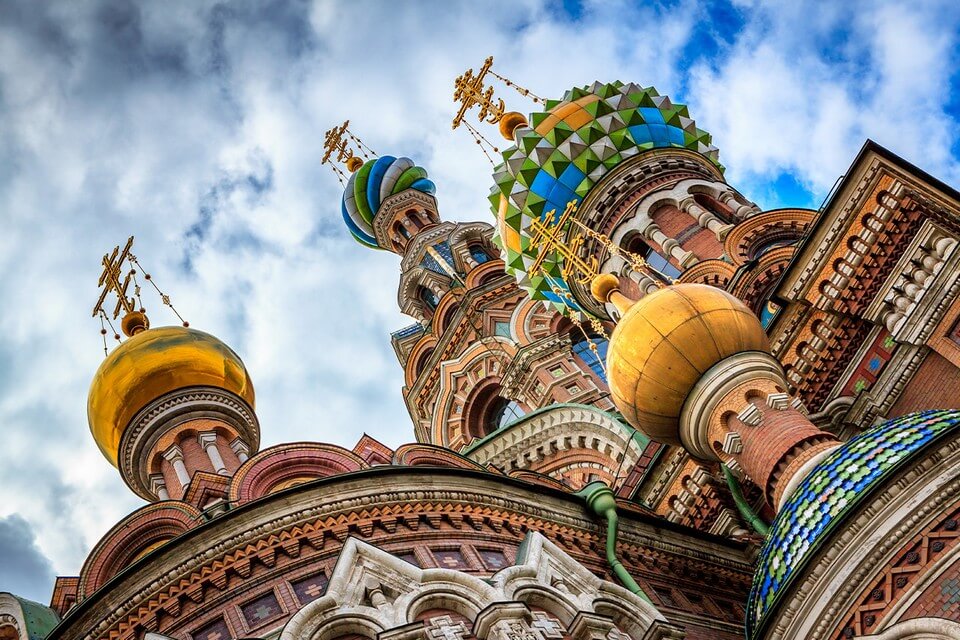 View of the top of a colorful cathedral from the ground. Colorful domes of a cathedral.