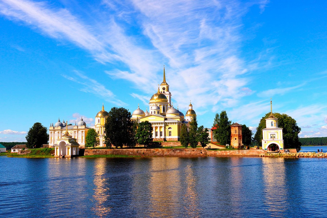 A view of an ensemble of several cathedrals on a small island in the middle of a lake.