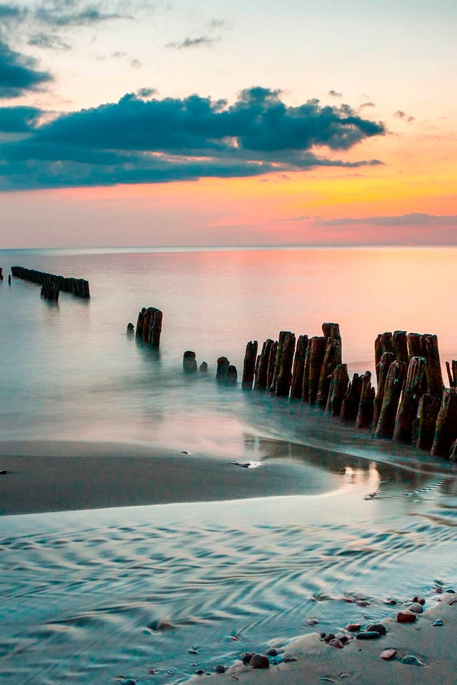 Wooden Groynes in the sea, sea during the sunset