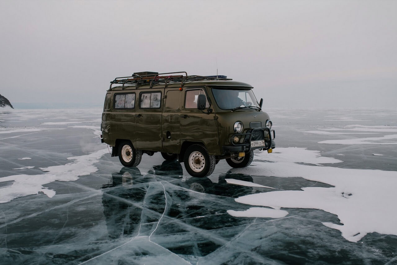 An off-road van on the ice of a lake