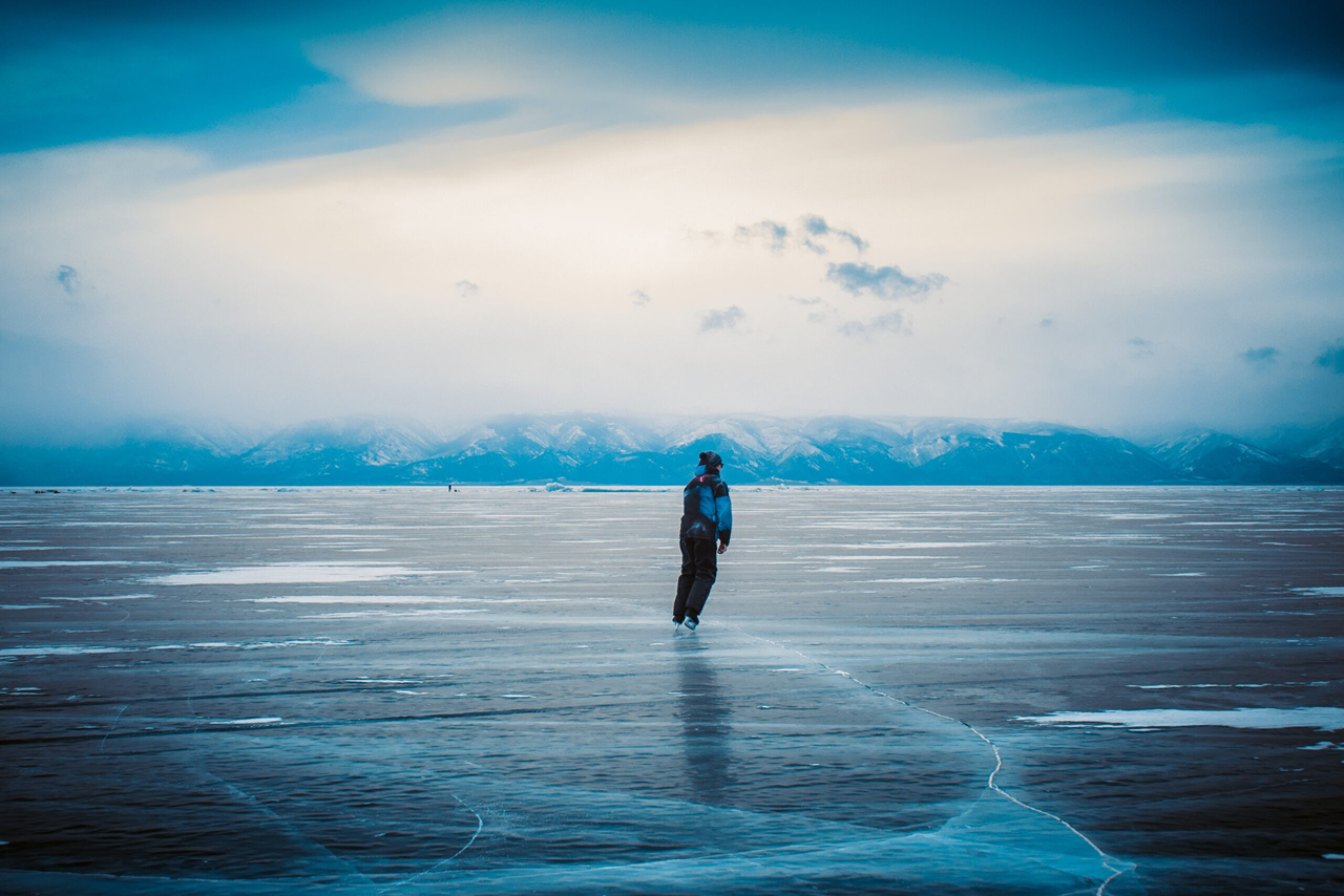 A person ice skating on an endless frozen lake