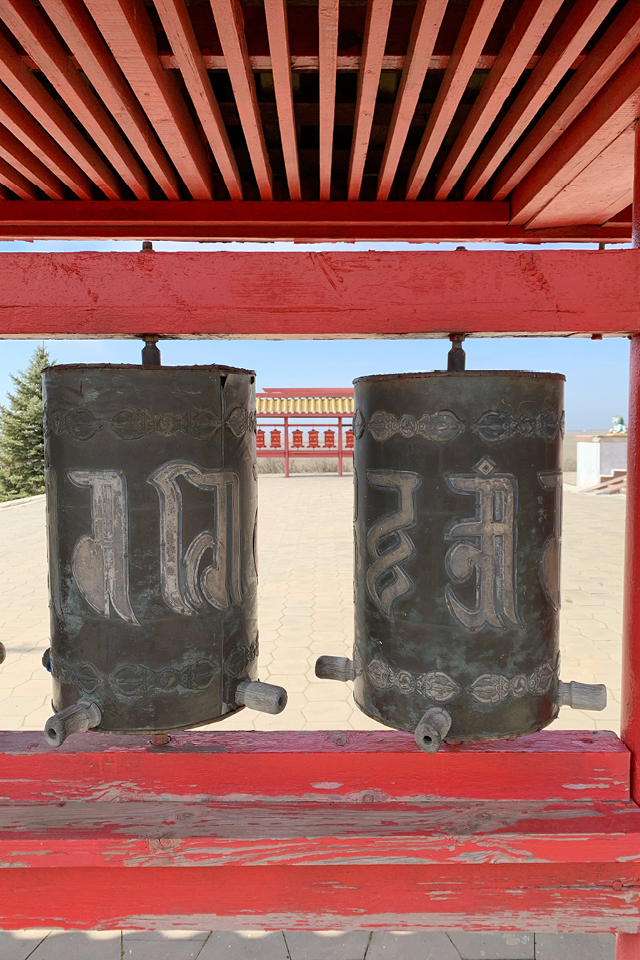 Brown prayer wheels in a Buddhist temple