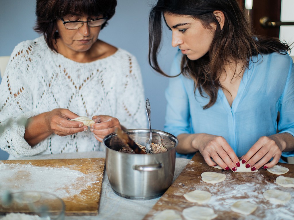 Two women cooking together, two women making dumplings