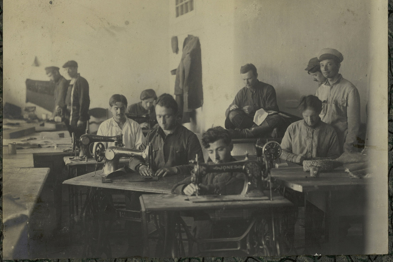 Black and white photo of people working in a labor camp