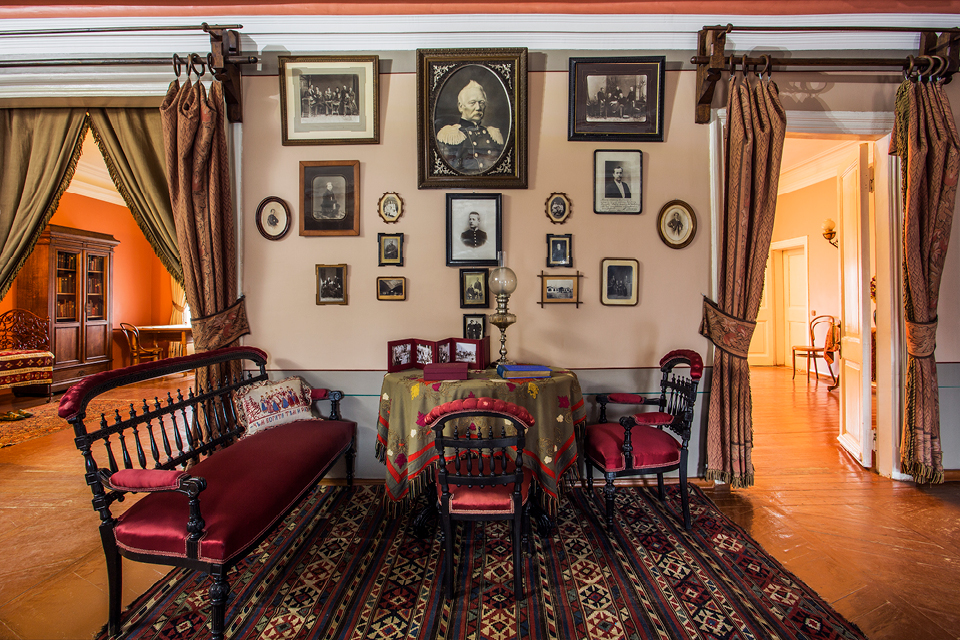 A room with vintage furniture, portraits on the wall, living room of a house of 19th century