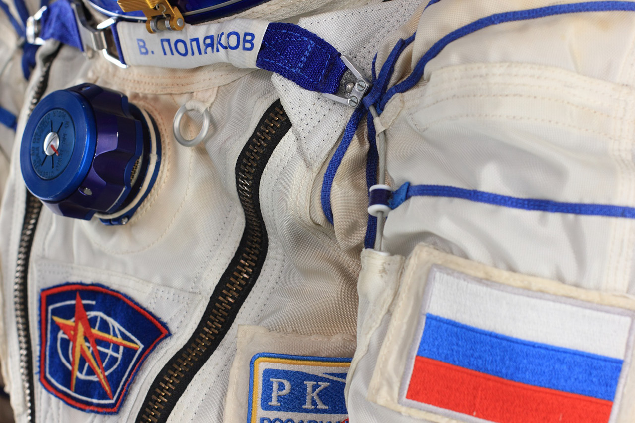 A part of a spacesuit of a Russian cosmonaut with his name and Russian flag on it