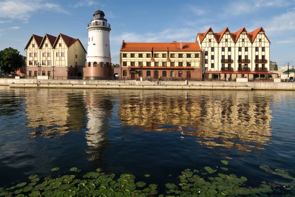 Buildings in German historical style on the embankment, timber-framed houses, lighthouse.