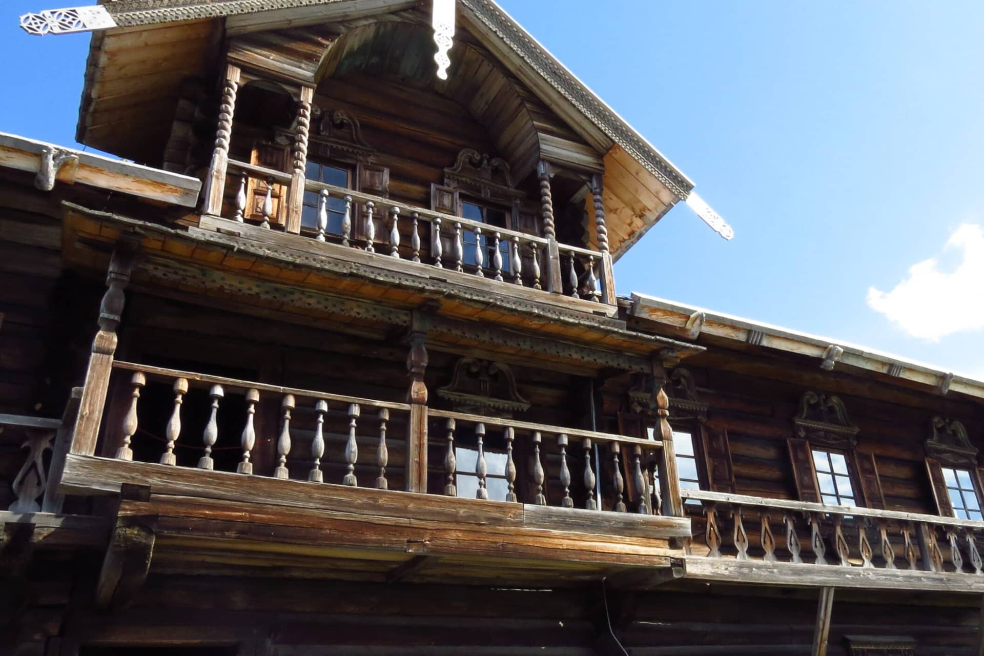 WoodA big wooden house with balconies decorated with balustrades