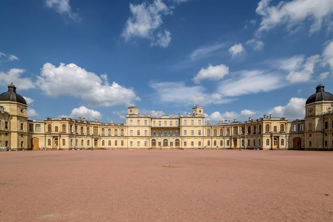 A palace looking like a castle with two symmetric wings , a square in front of it
