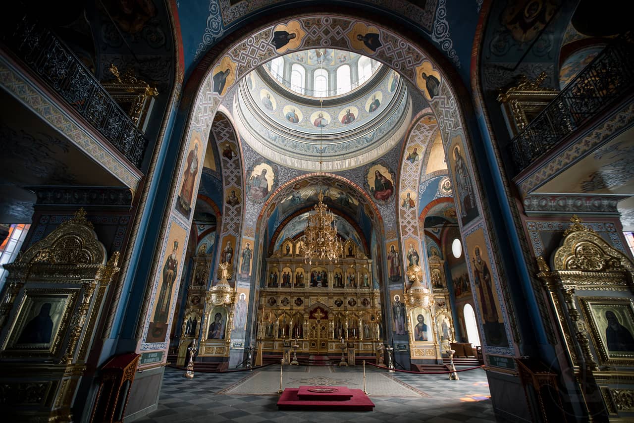 Interior of an orthodox church, arches of a church decorated with colorful frescoes