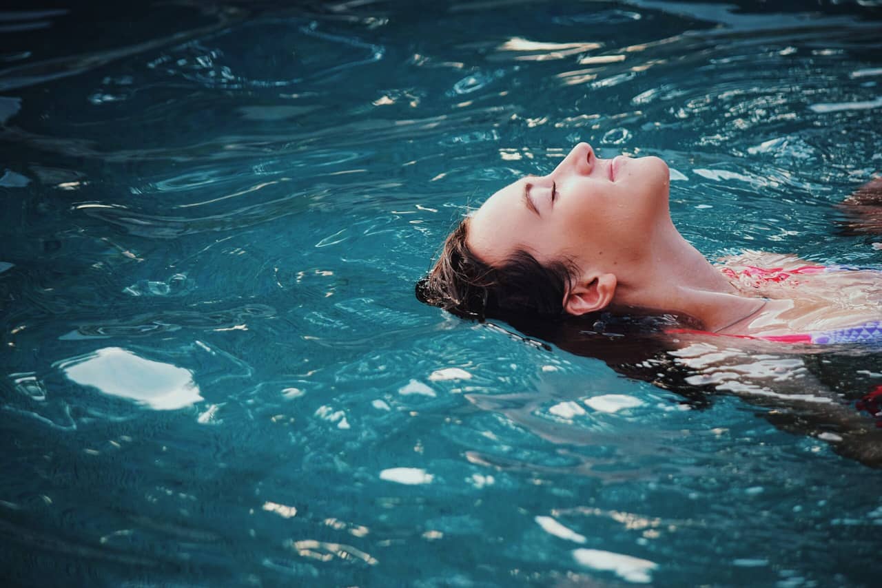 A head of a woman in a swimming pool