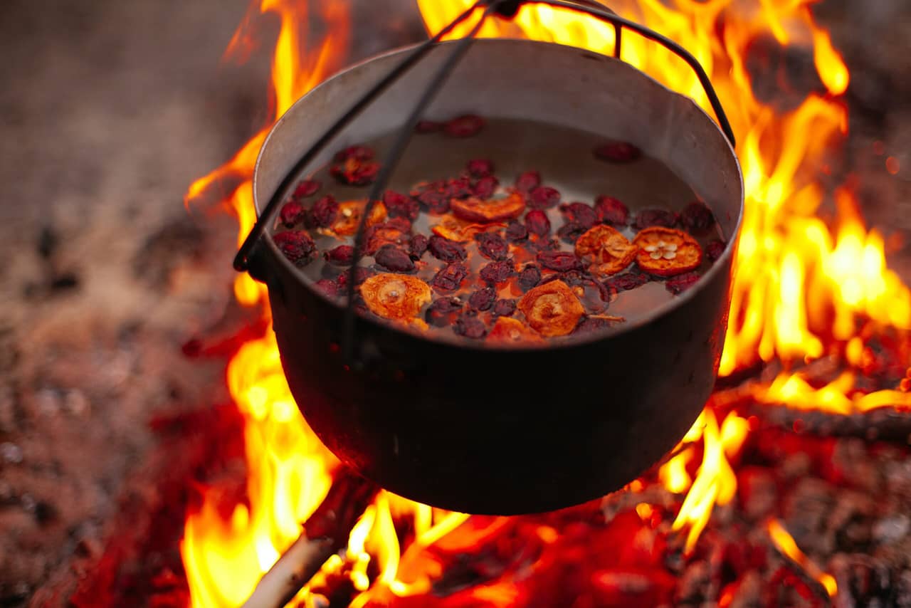 A pot on fire, dried fruits in a cooking pot