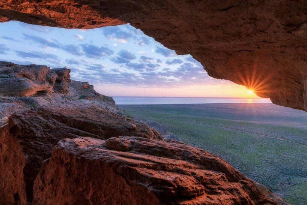 A view of a salt lake and beautiful sunset from a cave