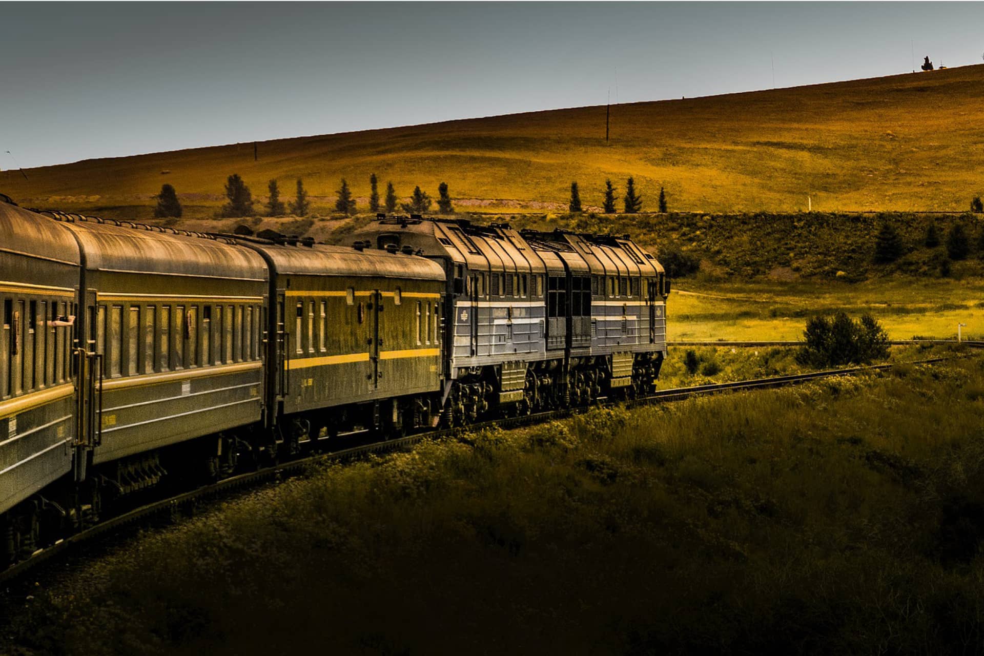 A train on the way in beautiful landscape, green fields