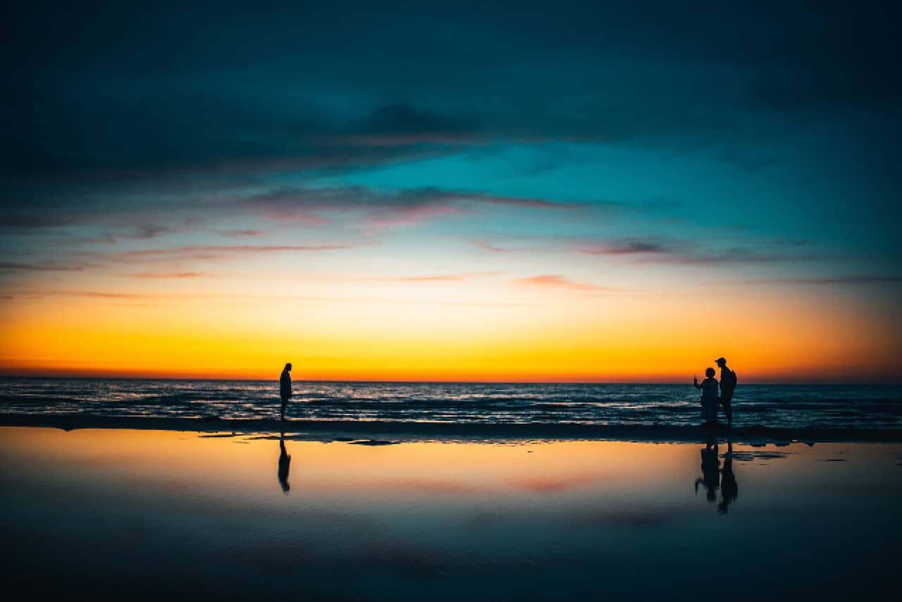 People at a beach during the sunset