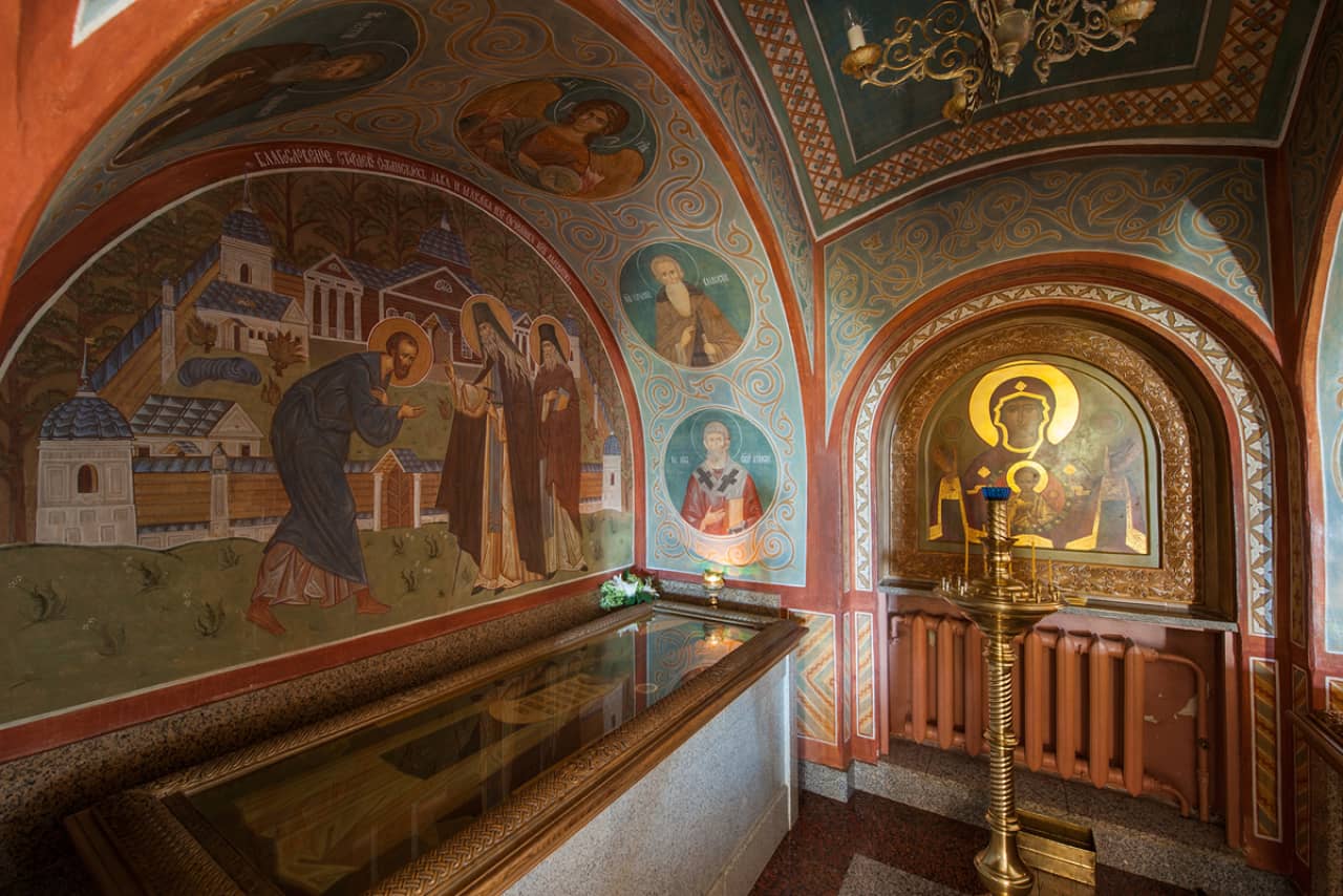 Interior of an Eastern Orthodox church, wall with images of Christian saints, Holy relic