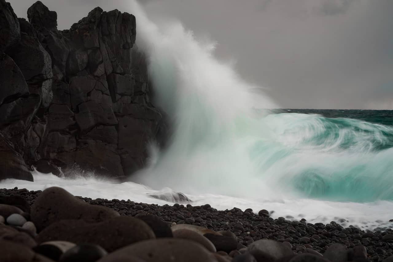 A wave breaking with a rock