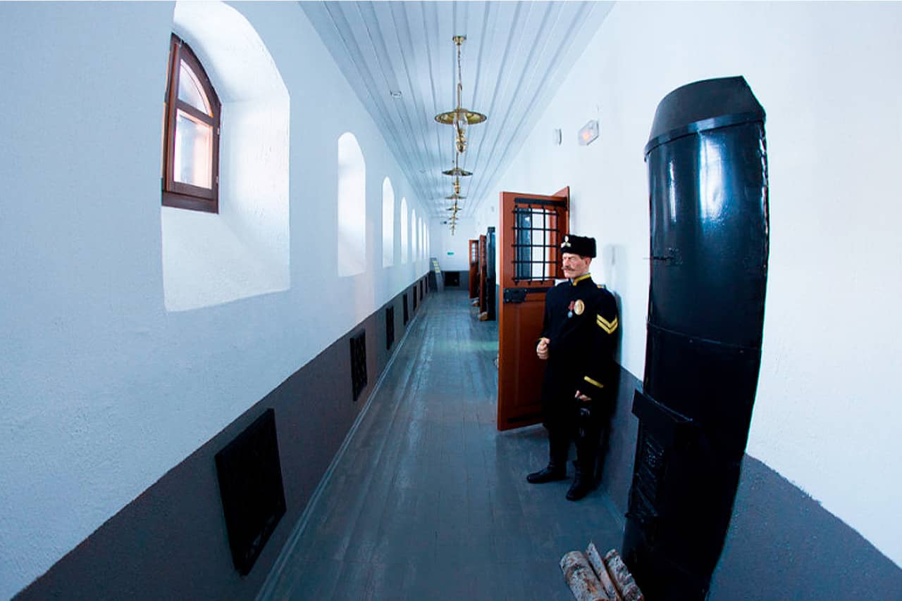 A corridor in a prison, a vax sculpture of a prison guard