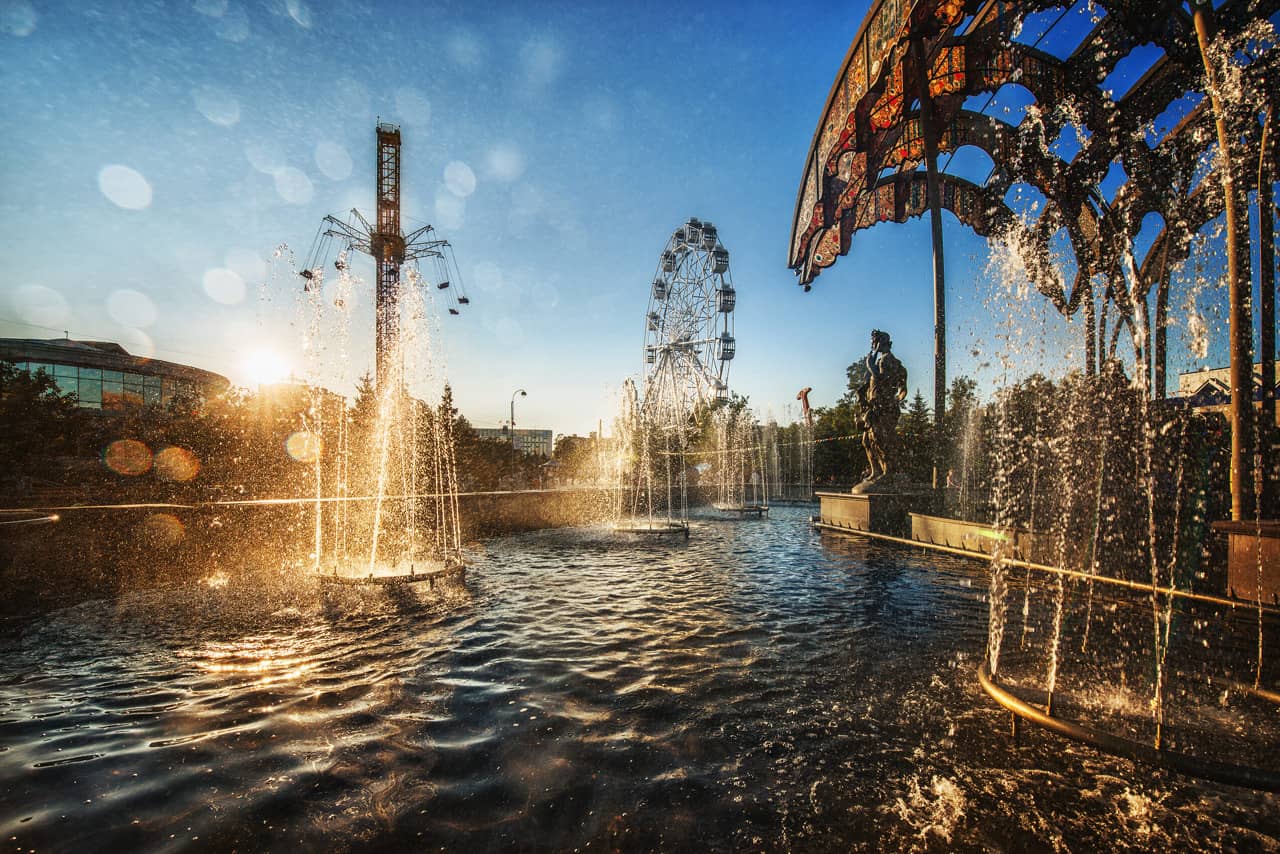 The area with fountains and an observation wheel at the backgrounds